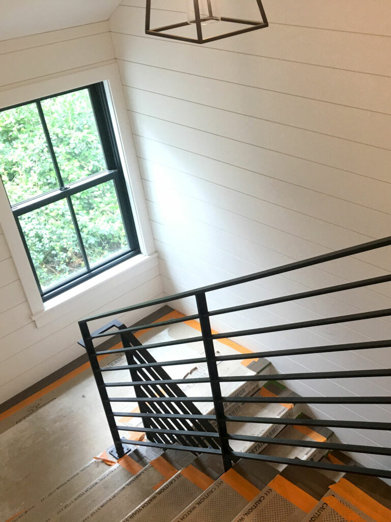 Horizontal Metal Guardrails for Stairway in Farmhouse Style Home - going down